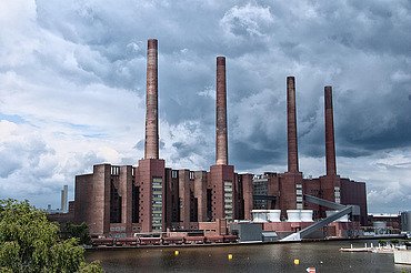 Exterior view of the VW plant in Wolfsburg, large brick factory with 4 chimneys