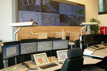 Picture of the Styrian control center with control center desks and a large video wall