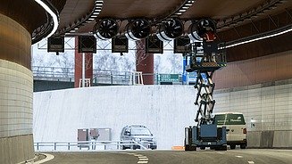 The image shows repair work being carried out on a fan inside a tunnel