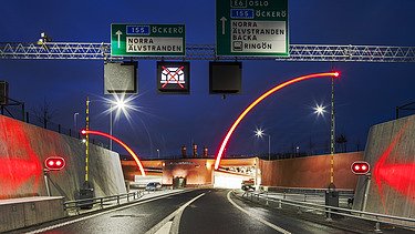 Entrance to the Marieholm Tunnel with illuminated barrier system in the dark