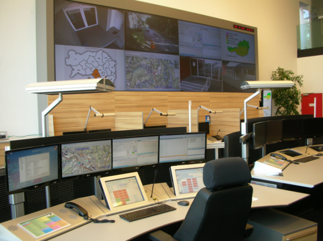 Picture of the Styrian control center with control center desks and a large video wall