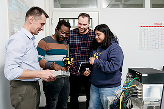 Image of four people looking at a product