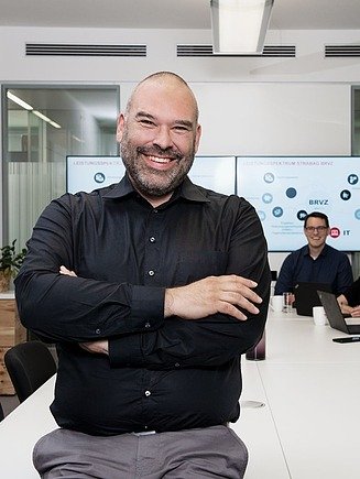 Picture of a man sitting on the desk in a meeting room